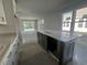 Kitchen island with dark gray cabinetry with an eat-in bar top and stainless appliances at 1233 Lady Bird Way, North Myrtle Beach, SC 29582