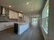Bright kitchen with stainless steel appliances, gray backsplash, and spacious open-concept layout at 1233 Lady Bird Way, North Myrtle Beach, SC 29582