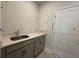 Bright laundry room featuring a white quartz countertop and neutral gray cabinetry for ample storage space at 1233 Lady Bird Way, North Myrtle Beach, SC 29582