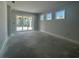 Unfinished living room with large windows and a sliding glass door leading to the backyard at 1233 Lady Bird Way, North Myrtle Beach, SC 29582