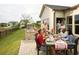 Residents having a meal at an outdoor patio table with a BBQ grill at 1233 Lady Bird Way, North Myrtle Beach, SC 29582