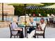 Residents at the community pool, seated at an umbrella-covered table enjoying food and beverages at 1233 Lady Bird Way, North Myrtle Beach, SC 29582