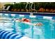 Personal relaxing at the edge of the outdoor community pool on a sunny day at 1233 Lady Bird Way, North Myrtle Beach, SC 29582