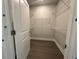 Walk-in closet with metal shelving and wood-look flooring at 1233 Lady Bird Way, North Myrtle Beach, SC 29582