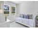 Bright bedroom featuring two large windows, daybed, and neutral decor at 124 Hoffman Park Dr. # 01, Myrtle Beach, SC 29588