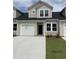 Charming townhome featuring a one car garage, neutral siding, and well-manicured lawn at 124 Hoffman Park Dr. # 01, Myrtle Beach, SC 29588