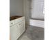 Bathroom area showcasing white cabinets, unfinished floors, and a new bathtub; awaiting your personal design touch at 1249 Lady Bird Way, North Myrtle Beach, SC 29582