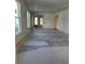 Unfinished living room with large windows, natural wood trim, and an unfinished floor that awaits your personal touch at 1249 Lady Bird Way, North Myrtle Beach, SC 29582