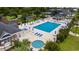 Aerial view of a community pool with lounge chairs, tables, and umbrellas, perfect for relaxing at 1315 Ashboro Ct., Myrtle Beach, SC 29579