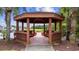 Inviting wooden gazebo with seating overlooks a peaceful waterfront view, perfect for relaxation at 1315 Ashboro Ct., Myrtle Beach, SC 29579