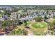 Aerial view of neighborhood showing golf course, pond, pool, and lush green landscaping at 136 Regency Dr., Conway, SC 29526