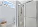 Bright bathroom featuring a glass-enclosed shower, tile floors, and a window for natural light at 136 Regency Dr., Conway, SC 29526