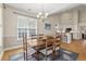 Spacious dining room with wooden table, six chairs, and an open transition into a modern kitchen at 136 Regency Dr., Conway, SC 29526