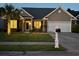 Charming single-story home with inviting front porch, well-maintained lawn, and two car garage at 136 Regency Dr., Conway, SC 29526
