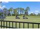 Lush green golf course visible from the home features electric golf carts at 136 Regency Dr., Conway, SC 29526
