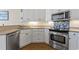 Modern kitchen features stainless steel appliances, white cabinets, and ample counter space at 136 Regency Dr., Conway, SC 29526