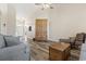 Open-concept living room with laminate floors boasts natural light and comfortable seating, enhancing its appeal at 136 Regency Dr., Conway, SC 29526