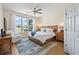 Comfortable bedroom with king bed, ceiling fan, large window overlooking backyard, and wood furnishings at 136 Regency Dr., Conway, SC 29526