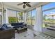 Cozy sun room boasts a ceiling fan, tile floors, and lovely views of the golf course at 136 Regency Dr., Conway, SC 29526