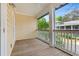Covered outdoor balcony with wood flooring and railing, offering a view of lush greenery at 138 Lumbee Circle # 17, Pawleys Island, SC 29585