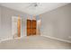 Light-filled bedroom with carpet, ceiling fan, and wood closet doors, offering comfort and style at 138 Lumbee Circle # 17, Pawleys Island, SC 29585