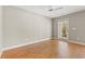 Bright bedroom with hardwood floors, a ceiling fan, and access to a balcony at 138 Lumbee Circle # 17, Pawleys Island, SC 29585
