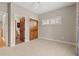 Cozy bedroom with carpet, ceiling fan, windows and wooden closet doors leading to bathroom and hallway at 138 Lumbee Circle # 17, Pawleys Island, SC 29585