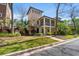 Charming two-story home with a porch, lush landscaping, and inviting curb appeal at 138 Lumbee Circle # 17, Pawleys Island, SC 29585