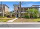 Inviting two-story home with a porch, lush landscaping, and inviting curb appeal at 138 Lumbee Circle # 17, Pawleys Island, SC 29585