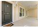Inviting front porch with a ceiling fan, cream walls, and black front door at 138 Lumbee Circle # 17, Pawleys Island, SC 29585