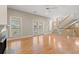 Bright living room with hardwood floors, fireplace, staircase, and access to outdoor patio through french doors at 138 Lumbee Circle # 17, Pawleys Island, SC 29585