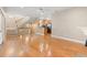 Open living space showcasing hardwood floors, staircase, and a view of the adjacent kitchen at 138 Lumbee Circle # 17, Pawleys Island, SC 29585
