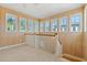 Loft space featuring wood walls, carpet, white trim, railings and natural light from the numerous windows at 138 Lumbee Circle # 17, Pawleys Island, SC 29585