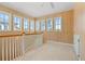 Bright loft space featuring wood walls, carpet, white trim and numerous windows to let the sun shine in at 138 Lumbee Circle # 17, Pawleys Island, SC 29585