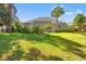 Lush backyard featuring a patio with seating, mature trees, and a well-manicured lawn at 141 Wickham Ct., Pawleys Island, SC 29585