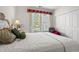 Bright bedroom with floral bedding, window, and closet at 141 Wickham Ct., Pawleys Island, SC 29585