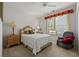 Cozy bedroom featuring a patterned headboard, sitting chair, and bright window at 141 Wickham Ct., Pawleys Island, SC 29585