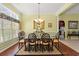 Elegant dining room featuring hardwood floors, a large window, and a chandelier over a glass dining table at 141 Wickham Ct., Pawleys Island, SC 29585