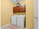 Laundry room featuring a washer, dryer, and upper cabinets at 141 Wickham Ct., Pawleys Island, SC 29585