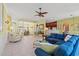 Spacious open-concept living room with tiled floors, a blue sofa, and views of the dining and kitchen areas at 141 Wickham Ct., Pawleys Island, SC 29585