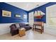 Living room with blue walls, built-in shelves, and decorative ship at 141 Wickham Ct., Pawleys Island, SC 29585