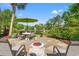 Outdoor patio area with pond view, seating, and a lush green landscape at 141 Wickham Ct., Pawleys Island, SC 29585