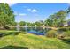 Scenic view of a community pond featuring a fountain and lush green surroundings at 141 Wickham Ct., Pawleys Island, SC 29585