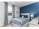 Stylishly decorated bedroom with a window, blue accent wall, and comfortable-looking bed at 1439 Nokota Dr., Conway, SC 29526