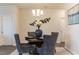 Elegant dining room featuring a round table with four chairs, modern lighting, and decorative wall art at 1439 Nokota Dr., Conway, SC 29526