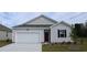 Charming single-Gathering home with a well-manicured lawn, attached garage, and a classic red front door at 1439 Nokota Dr., Conway, SC 29526