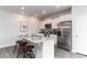Modern kitchen featuring stainless steel appliances, a granite countertop island with seating for three, and white cabinets at 1439 Nokota Dr., Conway, SC 29526