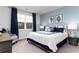 Serene bedroom featuring a large window with a scenic view, stylish decor, and blue accent pillows at 1439 Nokota Dr., Conway, SC 29526
