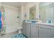 Bright bathroom with double vanity, gray cabinetry, and a shower-tub combo at 1447 Nokota Dr., Conway, SC 29526