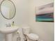 Clean half bathroom with a pedestal sink, round mirror, and neutral decor at 1447 Nokota Dr., Conway, SC 29526